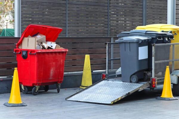 Junk Removal Services in Kent, WA – Clear Your Space with Ease Large garbage bins and containers being loaded onto a truck for disposal, representing professional Junk Removal Services Kent WA.